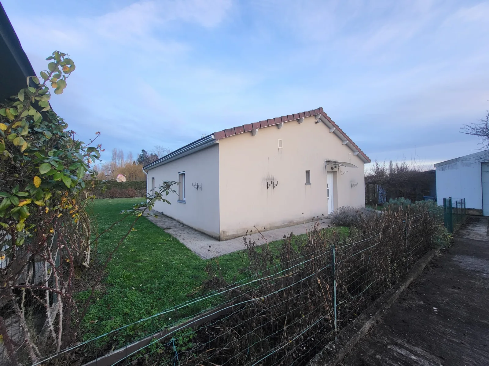 A single-storey house with a large garden